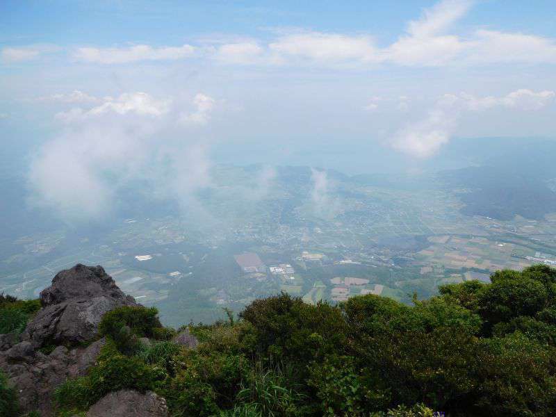 Photograph of The view from the top of the Kaimondake volcano. The summit is marked with a post, a perfect photo opportunity!