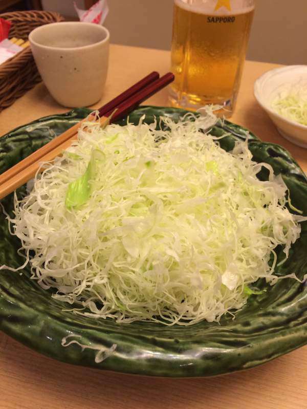 Photograph of Shredded cabbage is a regular side dish for Tonkatsu. We enjoyed this evening meal in Okayama train station, a surprisingly good food destination!